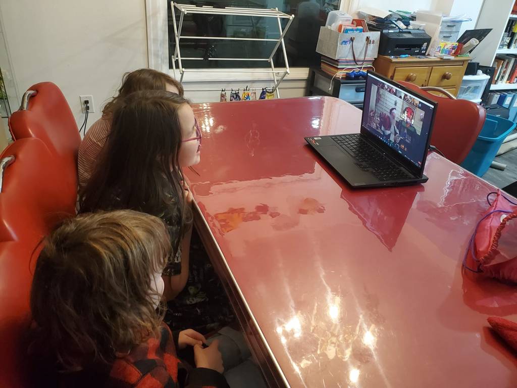 three children talking to santa on zoom call