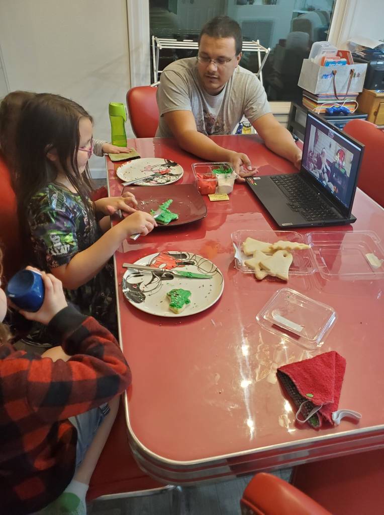 parent helping kids talk to santa on zoom call
